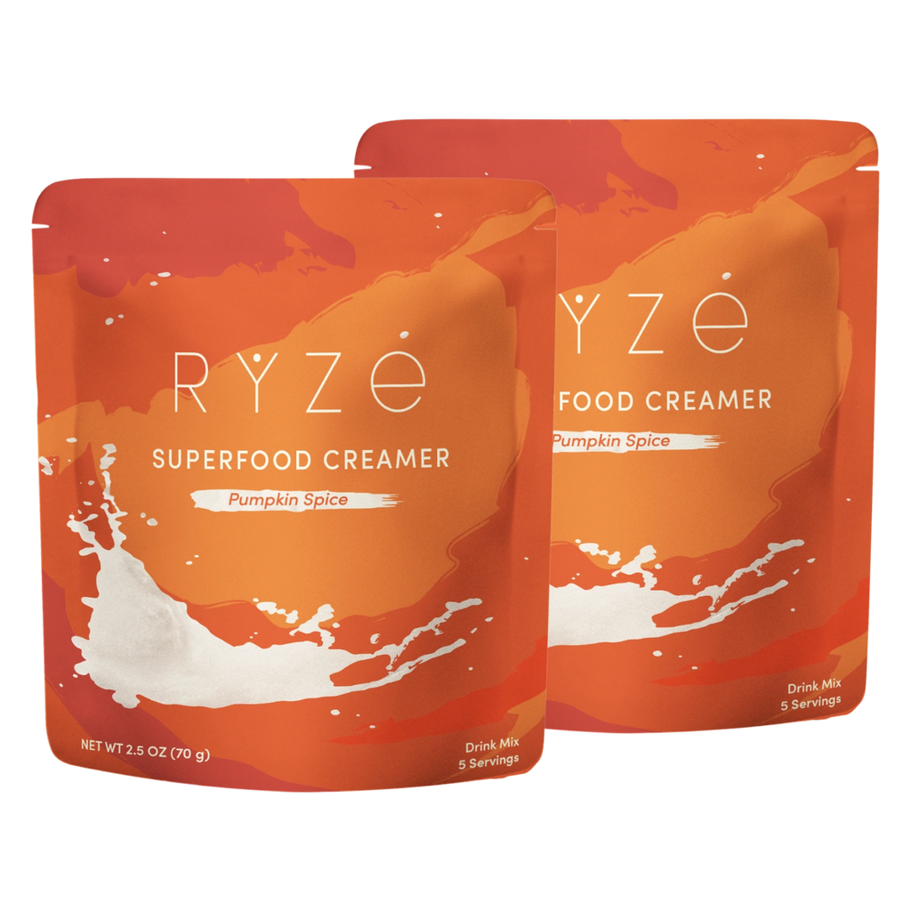 Two stand-up pouches of RYze Food Creamer in Pumpkin Spice flavor, shown overlapping on a plain white background.
