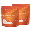 Two stand-up pouches of RYze Food Creamer in Pumpkin Spice flavor, shown overlapping on a plain white background.