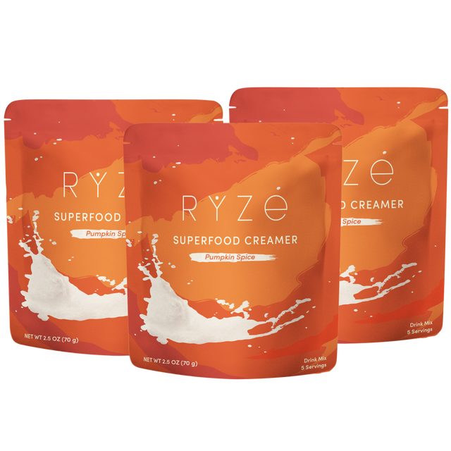 Three stand-up pouches of RYze Superfood Creamer in Pumpkin Spice flavor, arranged in a fan shape on a plain white background.