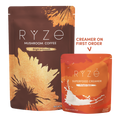 Two RYZE-branded pouches on a white background: a larger brown and gold Mushroom Coffee bag and a smaller orange and red Superfood Creamer pouch with a white splash graphic. Text on the image says 'CREATER ON FIRST ORDER' with an arrow pointing to the creamer pouch.